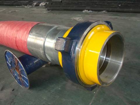 A large diameter rotary drilling hose are supported by a axle in the warehouse.
